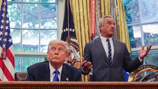 Secretary of Health and Human Services Robert F. Kennedy Jr. speaks to President Donald Trump during an executive orders signing event in the Oval Office.