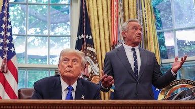 Secretary of Health and Human Services Robert F. Kennedy Jr. speaks to President Donald Trump during an executive orders signing event in the Oval Office.