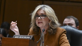 Marsha Blackburn gesticulates while speaking while seated.
