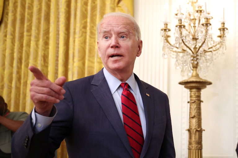 President Joe Biden points to the crowd as he departs a press conference.