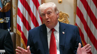 President Donald Trump splays his hands out while speaking at a Cabinet meeting.