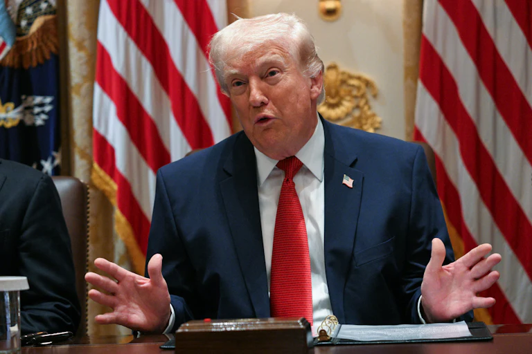 President Donald Trump splays his hands out while speaking at a Cabinet meeting.