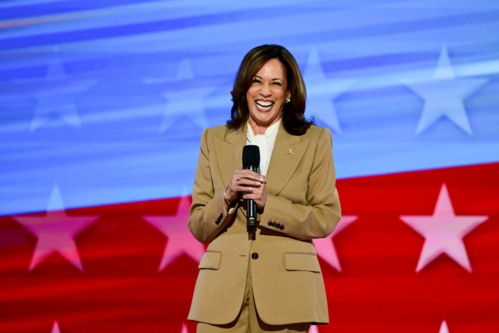 Kamala Harris smiles on stage