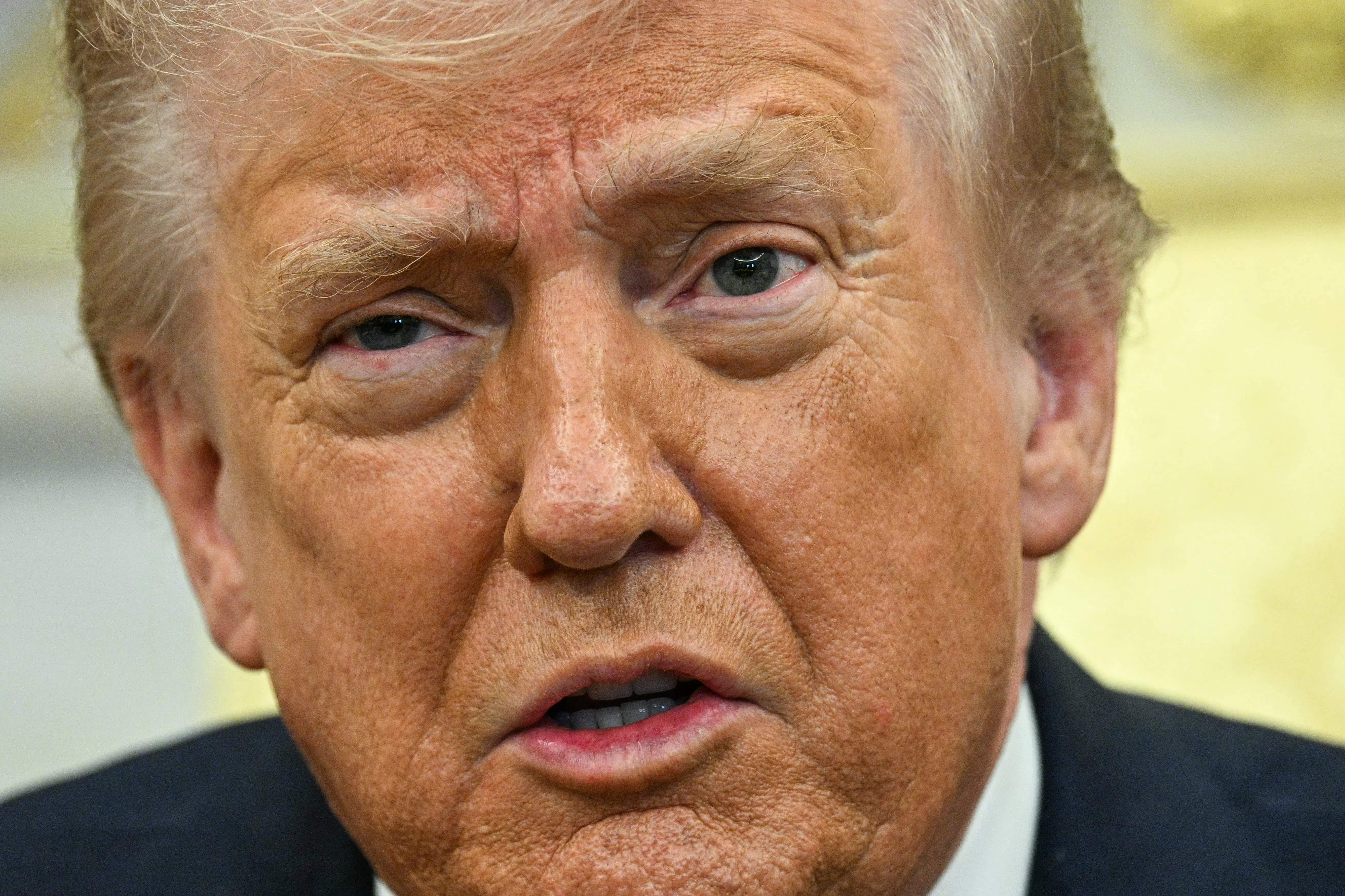 Donald Trump speaks to reporters in the Oval Office