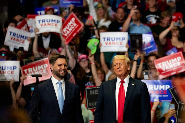 J.D. Vance and Donald Trump stand next to each other at a rally