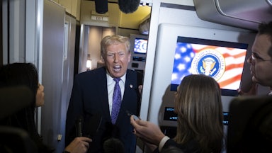 Donald Trump speaks to reporters on Air Force One