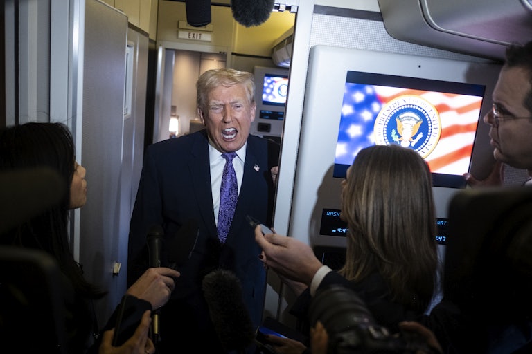 Donald Trump speaks to reporters on Air Force One