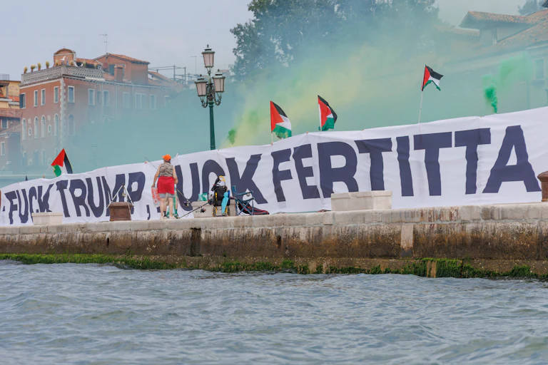 A sign that reads "Fuck Trump Fuck Fertitta" and lots of Palestinian flags.