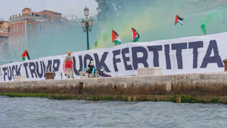 A sign that reads "Fuck Trump Fuck Fertitta" and lots of Palestinian flags.