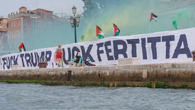 A sign that reads "Fuck Trump Fuck Fertitta" and lots of Palestinian flags.