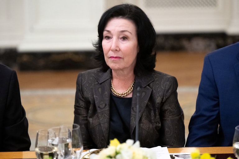 Safra Catz stares off into space at a dinner.