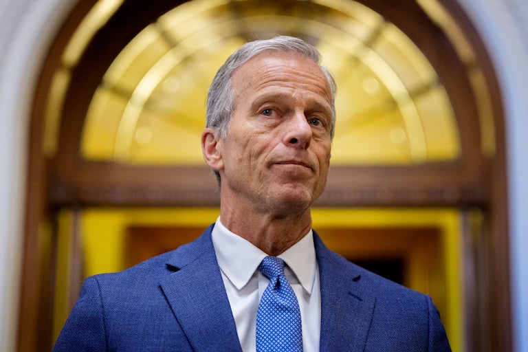 John Thune looks out in front of a doorway