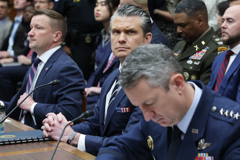 Assistant Defense Secretary Jules Hurst, Defense Secretary Pete Hegseth, and Chairman of the Joint Chiefs of Staff Dan Caine sit in a House committee hearing