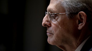 Merrick Garland looks down at his desk during a hearing.