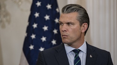 Defense Secretary Pete Hegseth purses his lips and turns his head to the side