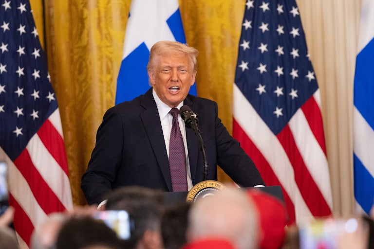Donald Trump speaks to a crowd at the White House