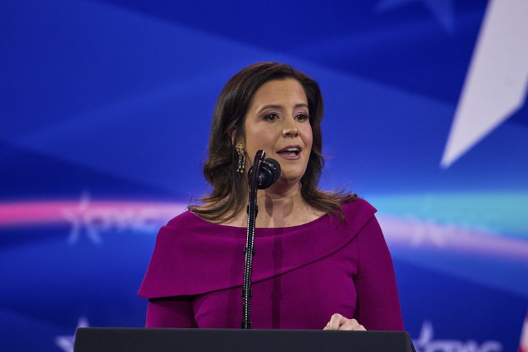 Representative Elise Stefanik speaks into a microphone at CPAC
