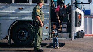 Haitian migrants leave a Border Patrol bus