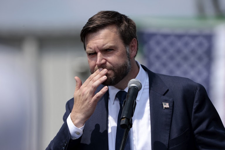 J.D. Vance touches his mouth while speaking during a Donald Trump campaign event