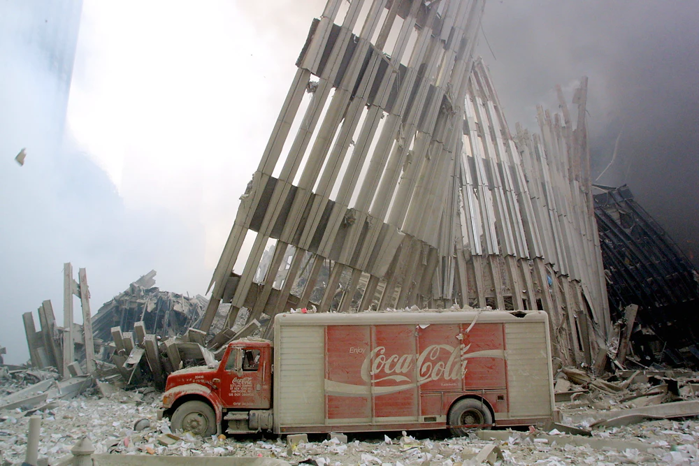 A dust-covered Coca-Cola delivery truck sits abandoned in the rubble and steel of the destroyed World Trade Center on September 11, 2001.