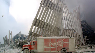 A dust-covered Coca-Cola delivery truck sits abandoned in the rubble and steel of the destroyed World Trade Center on September 11, 2001.