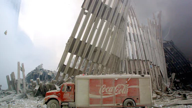 A dust-covered Coca-Cola delivery truck sits abandoned in the rubble and steel of the destroyed World Trade Center on September 11, 2001.