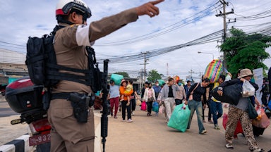Cambodian nationals at the Ban Khlong Luek border crossing on December 11, 2025, as clashes between Thailand and Cambodia continue.