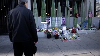 A person looks at a memorial for the two National Guard members who were shot in Washington, D.C.