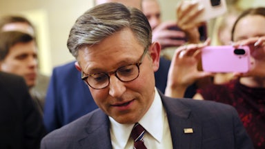 House Speaker Mike Johnson looks down while walking in the Capitol