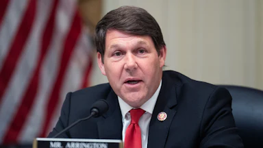 Representative Jodey Arrington speaks into a microphone during a House Budget Committee meeting