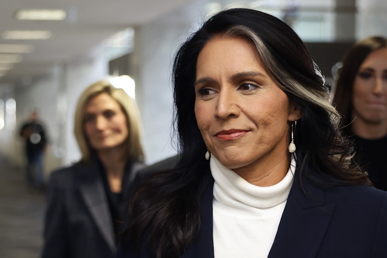 Tulsi Gabbard smiles while walking in the Capitol