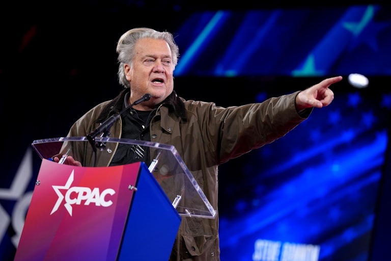 Steve Bannon points while speaking at a lectern at CPAC