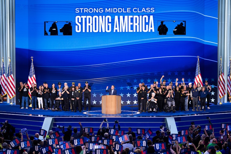 Teamsters union members stand on stage at the Democratic National Convention alongside Senator Gary Peters