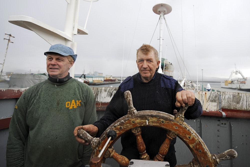 Whaler and captain Olafur Olafsson and his number two Hafstian Omar thorstainsson stand at the helm of a restored whaling vessel.