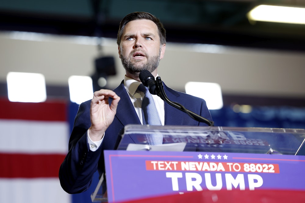J.D. Vance gestures while speaking at a podium.