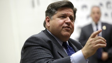 Governor JB Pritzker speaks while pointing.