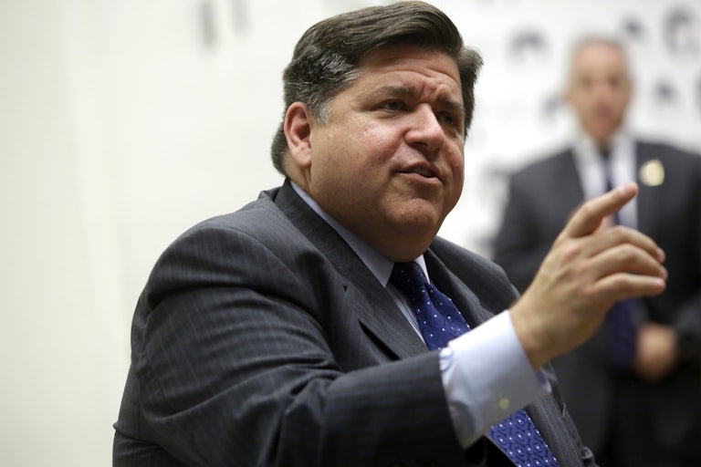 Governor JB Pritzker speaks while pointing.