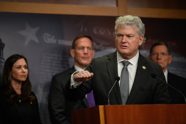 Represetative Mike Collins speaks at a press conference in the Capitol. Several other Republicans stand behind him.