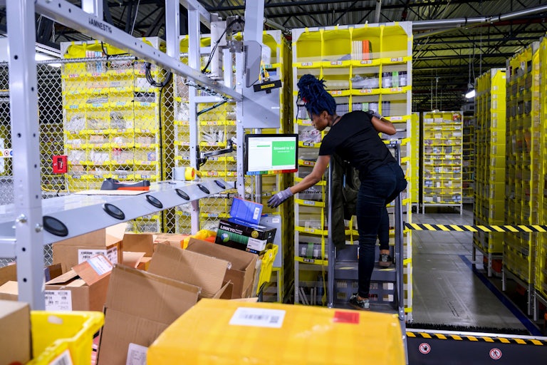 woman works at an Amazon warehouse