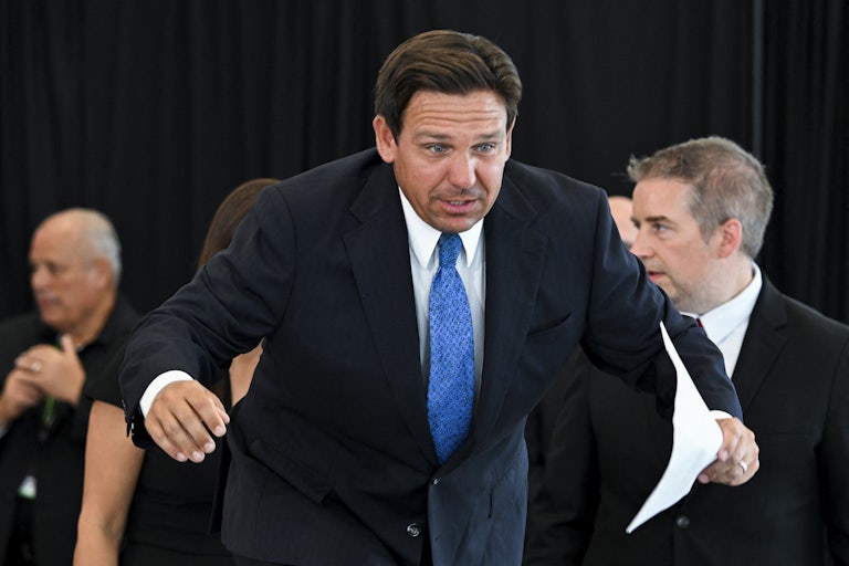Ron DeSantis bends over while walking