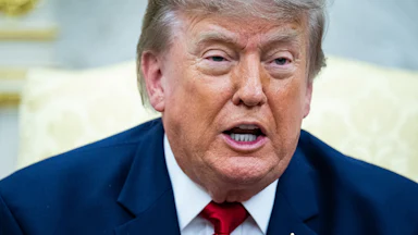 Donald Trump speaks while sitting in the Oval Office.