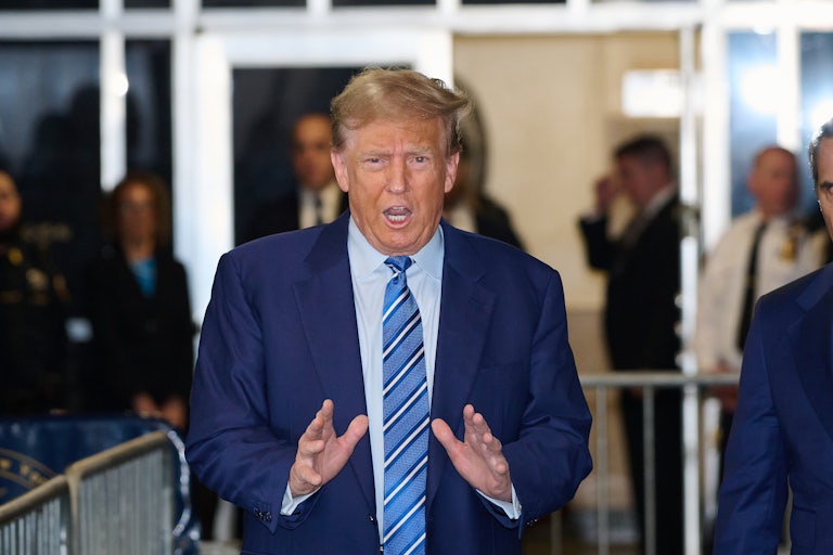 Donald Trump gestures with his hands as he speaks