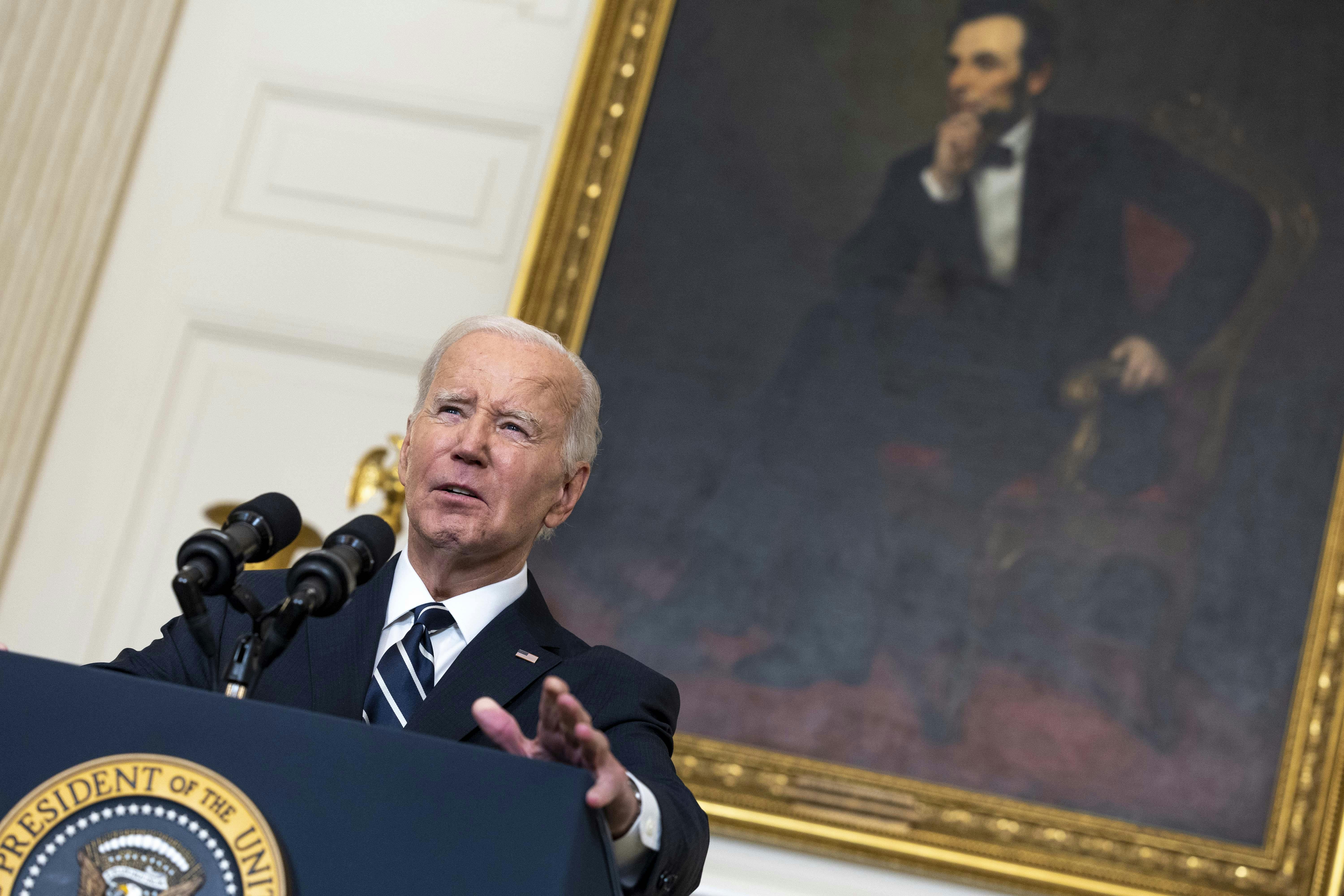 Biden stands in front of Lincoln painting