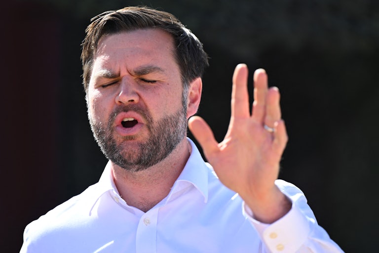 Vice President JD Vance closes his eyes and gestures while speaking