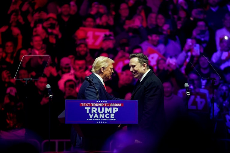 Donald Trump and Elon Musk shake hands on stage the night before Trump’s inauguration