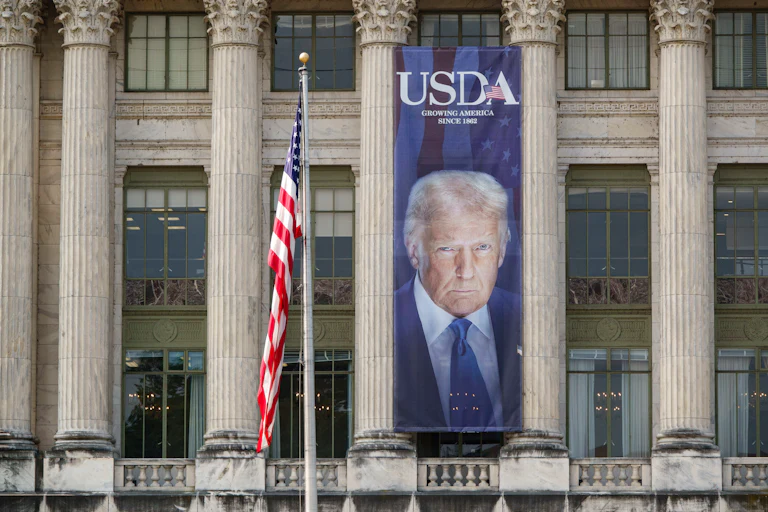 A large banner showing a picture of President Trump on the U.S. Department of Agriculture building reads "USDA Growing America Since 1862."