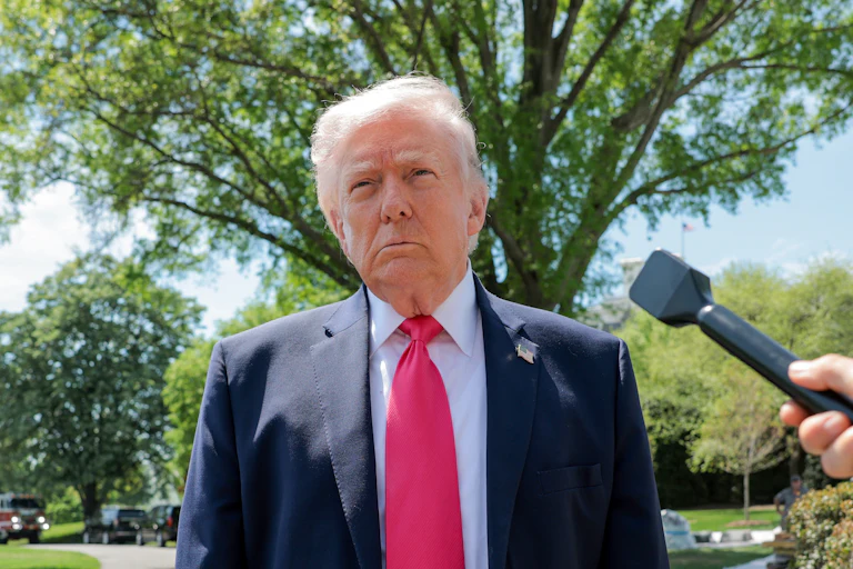 Donald Trump speaks with reporters outside the White House
