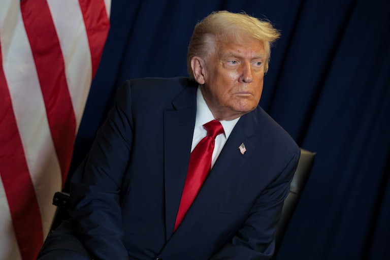 Donald Trump sits during a meeting at the U.N.