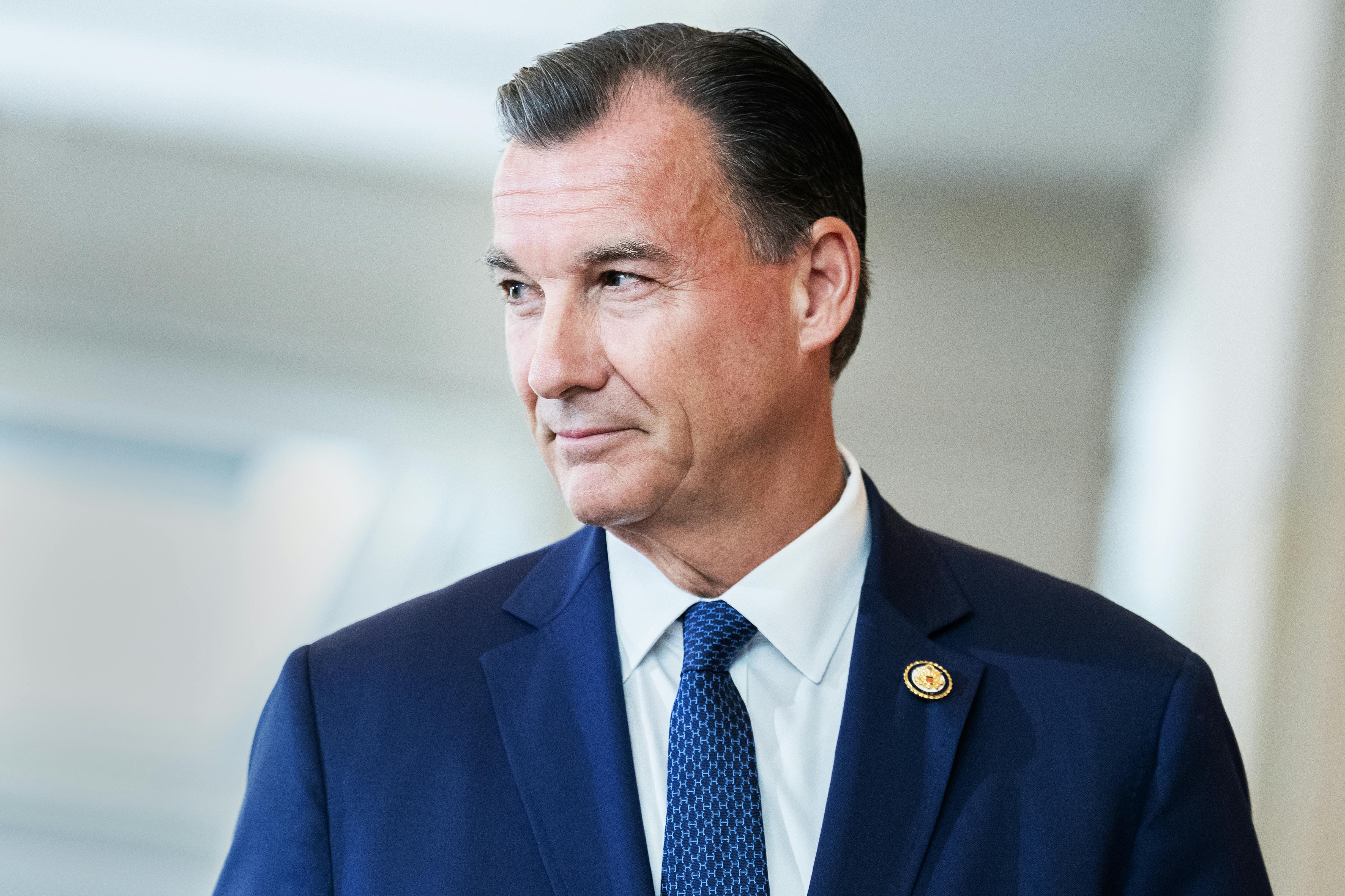 Representative Tom Suozzi looks to the side