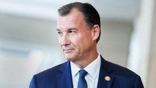 Representative Tom Suozzi looks to the side